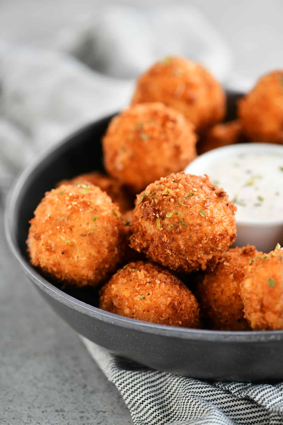 tray of fried corn poppers with a bowl of dip