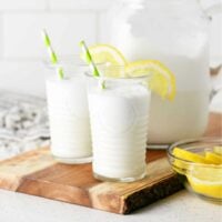 creamy lemonade whip in two glasses with lemon slices and straws