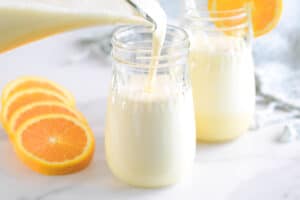 pouring orange whip into a glass