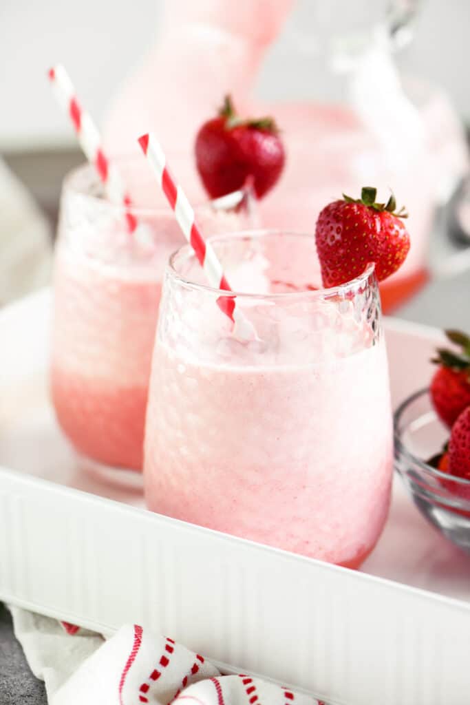 cups of creamy strawberry whip with garnish and a straw