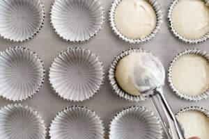 scooping batter into cupcake liners