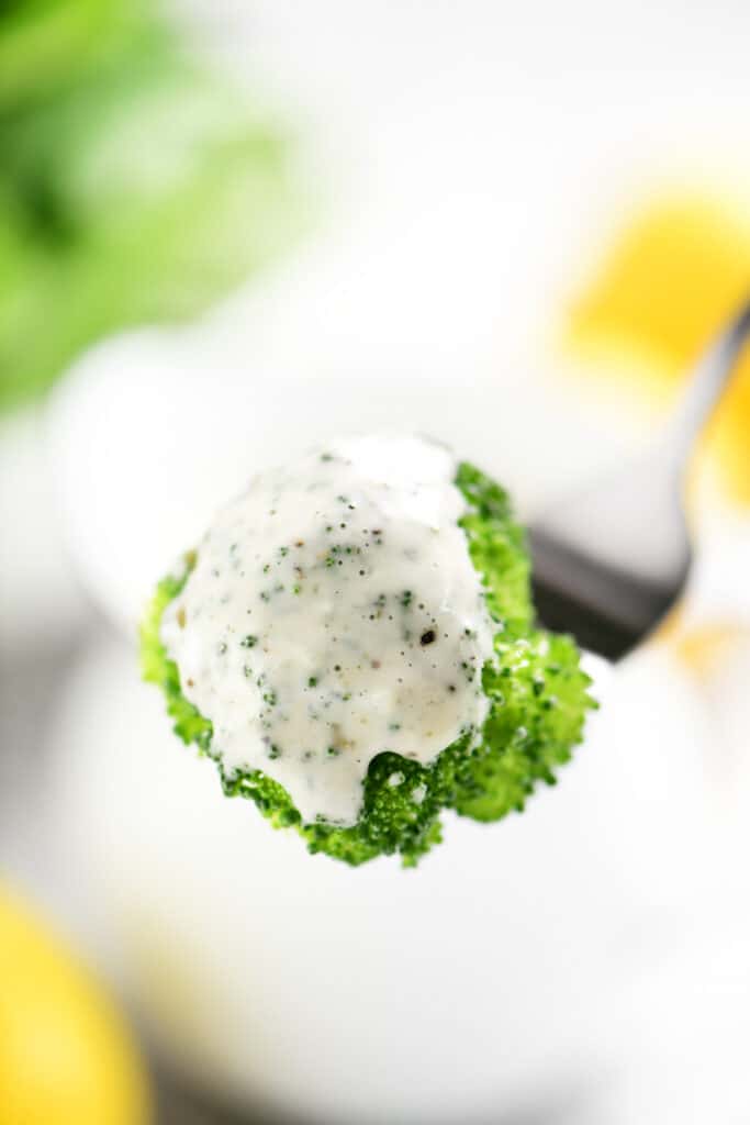 broccoli coated in a creamy white dip