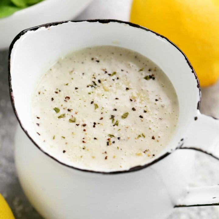 lemon vinaigrette in a white pitcher