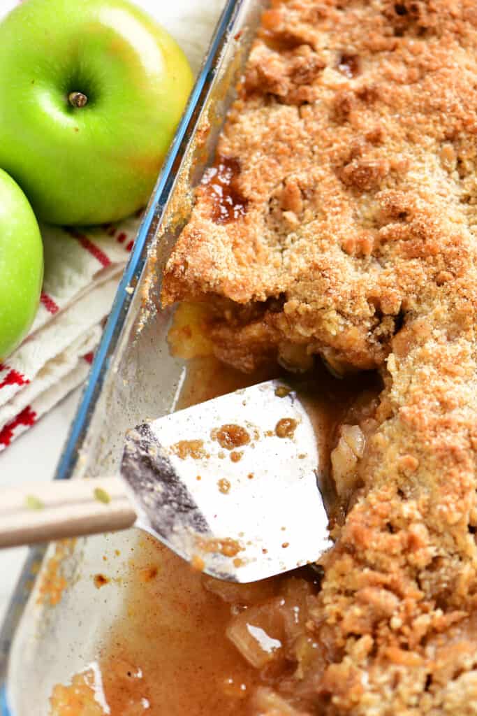 pie server in pan of apple crumble