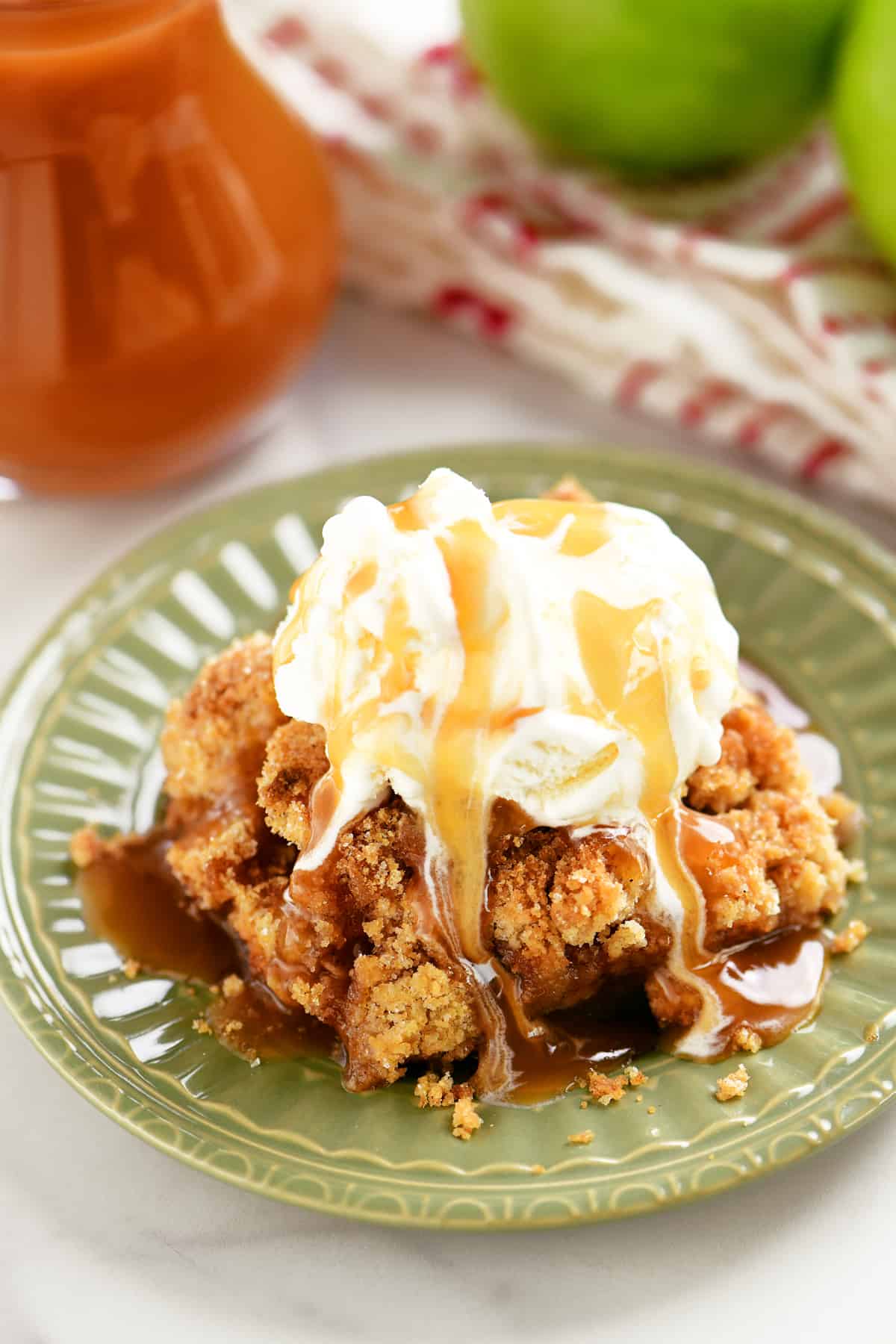 caramel drizzled over ice cream on top of apple crumble