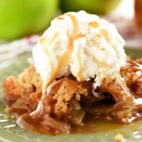 apple crumble on green plate with ice cream on top
