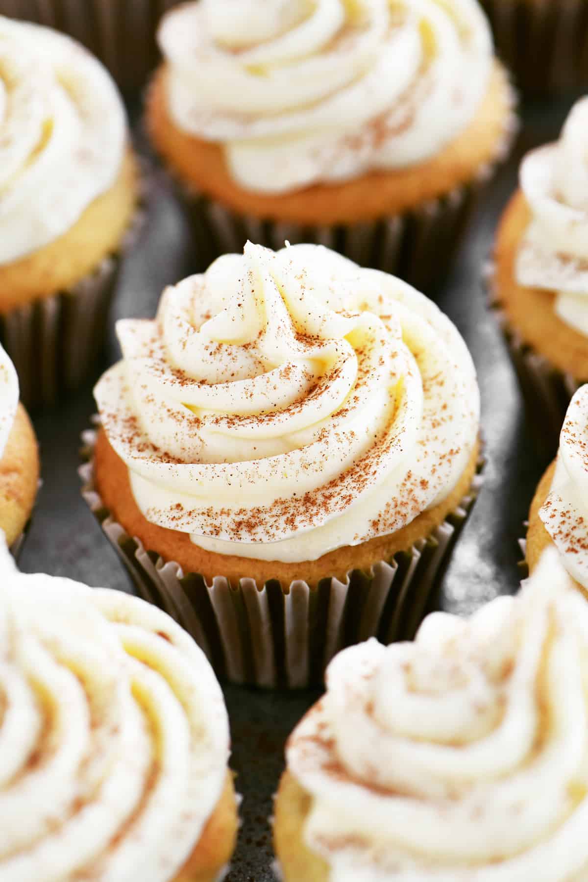 frosted cupcakes with cinnamon sprinkled on top