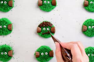 pipe melted chocolate mouth on frankenstein cookies