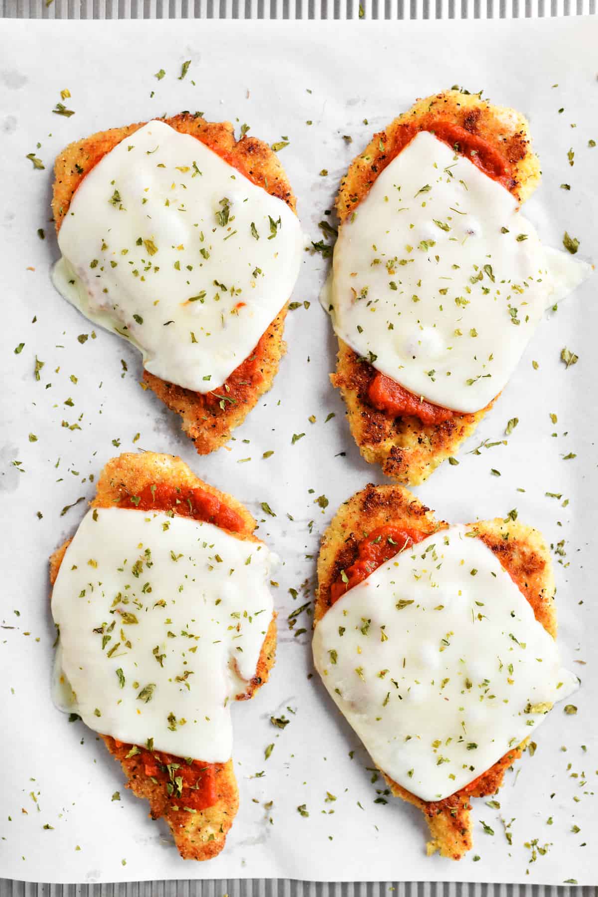 chicken parmesan baked on a pan