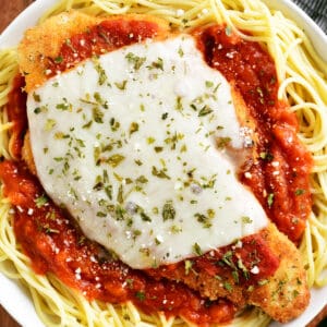 chicken parmesan on top of spaghetti