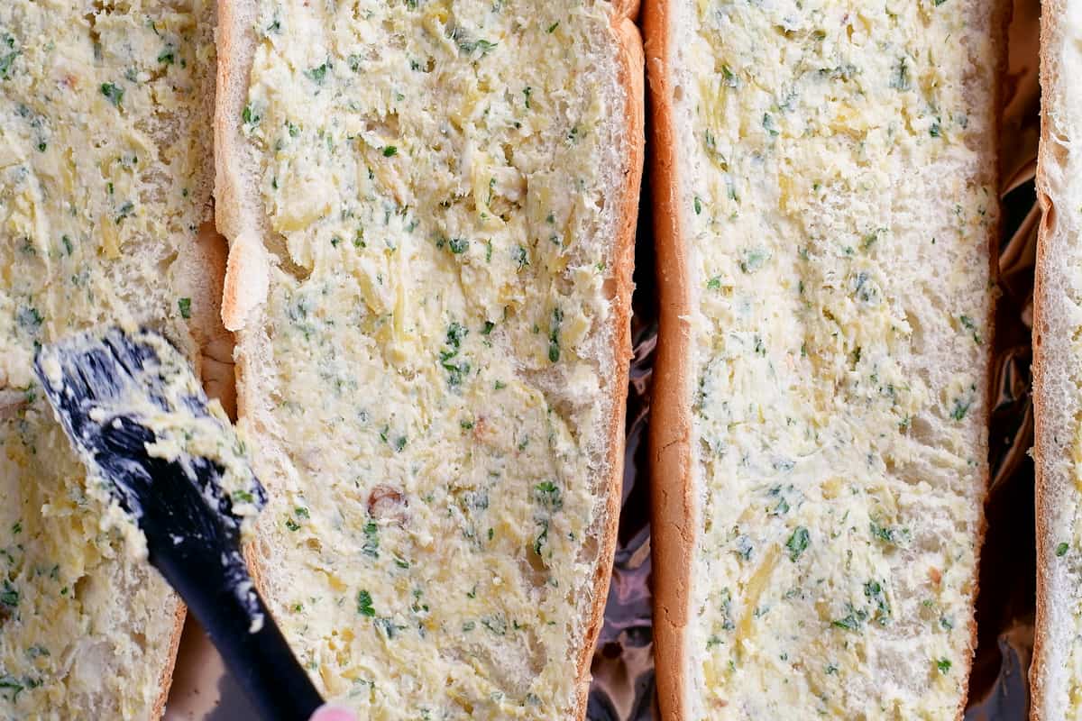 spread garlic butter over bread