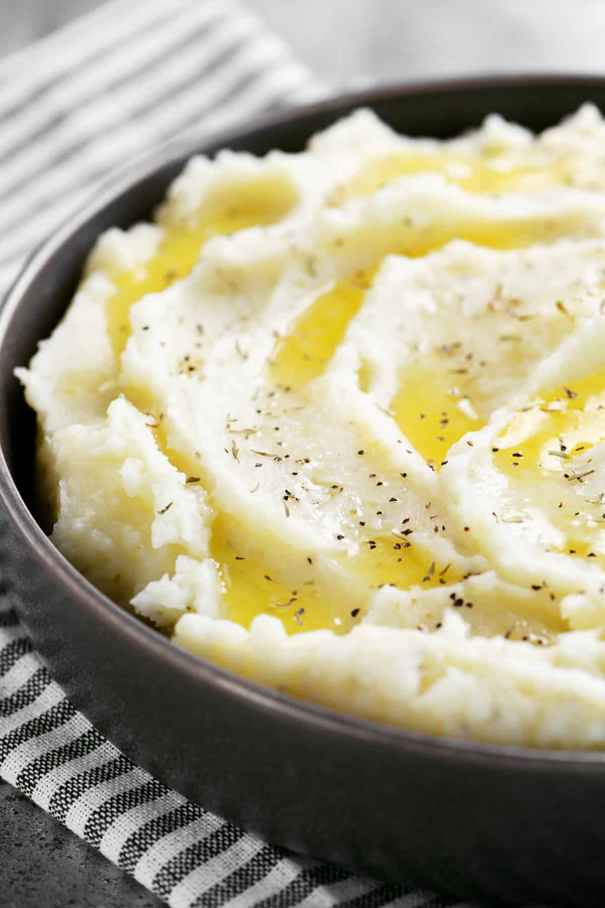 a serving dish filled with garlic mashed potatoes