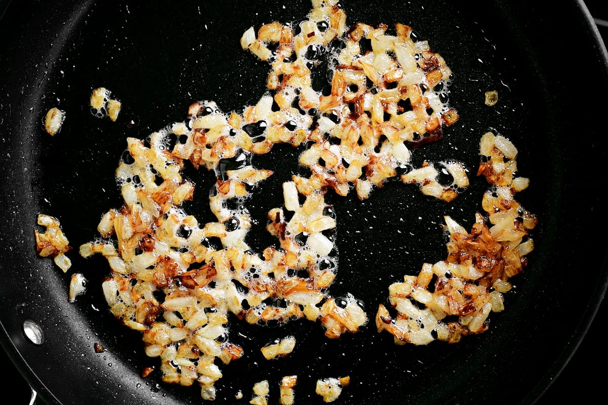 onions sautéing in a pan