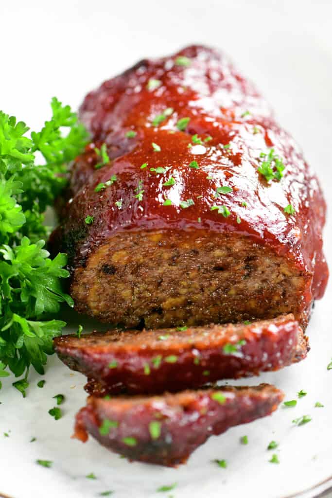sliced meatloaf with a parsley garnish