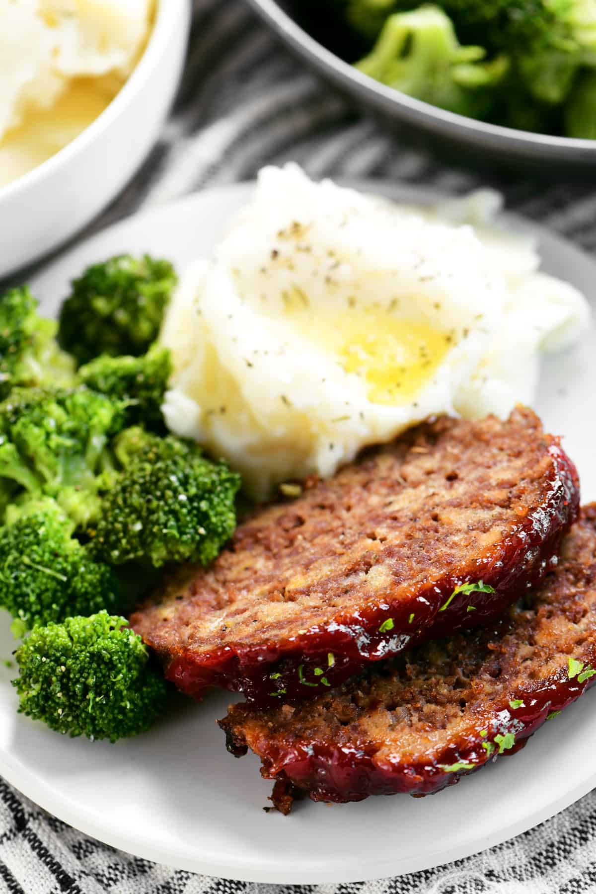meatloaf slices on a plate with vegetables
