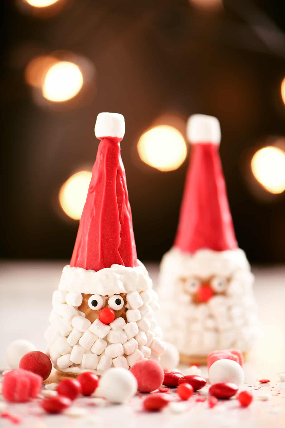 Santa Christmas cones and red and white candies on a table