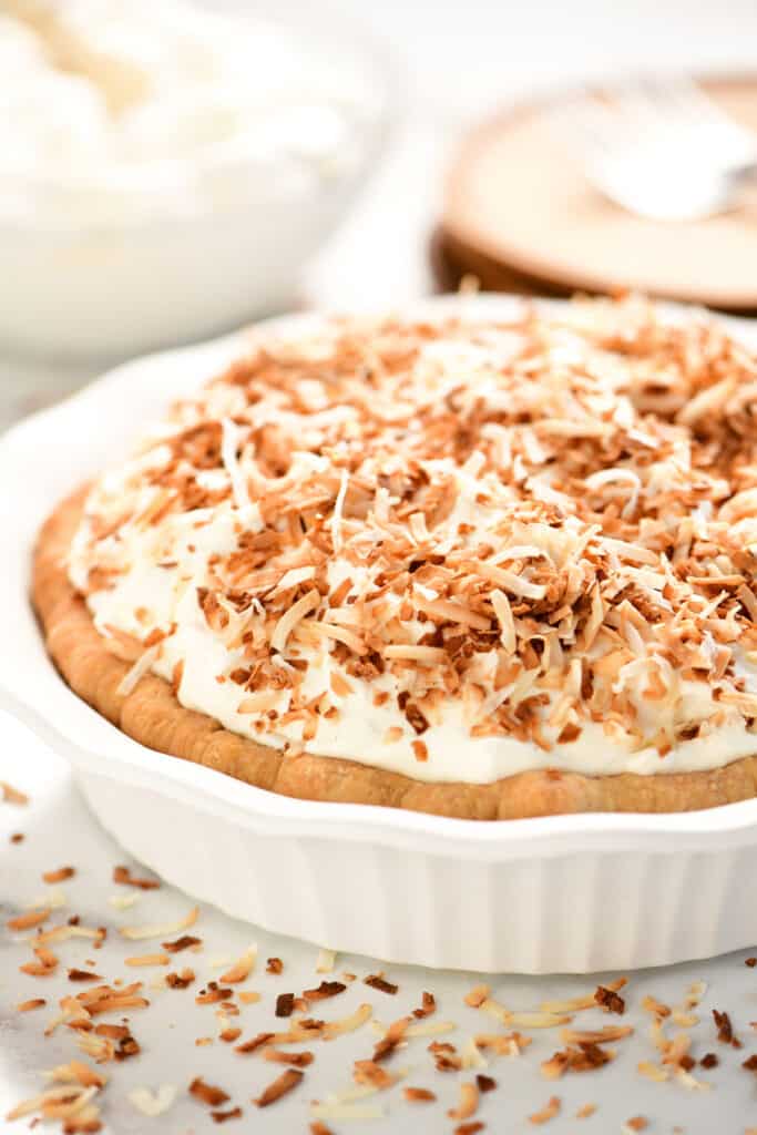 a pie dish with coconut cream pie inside