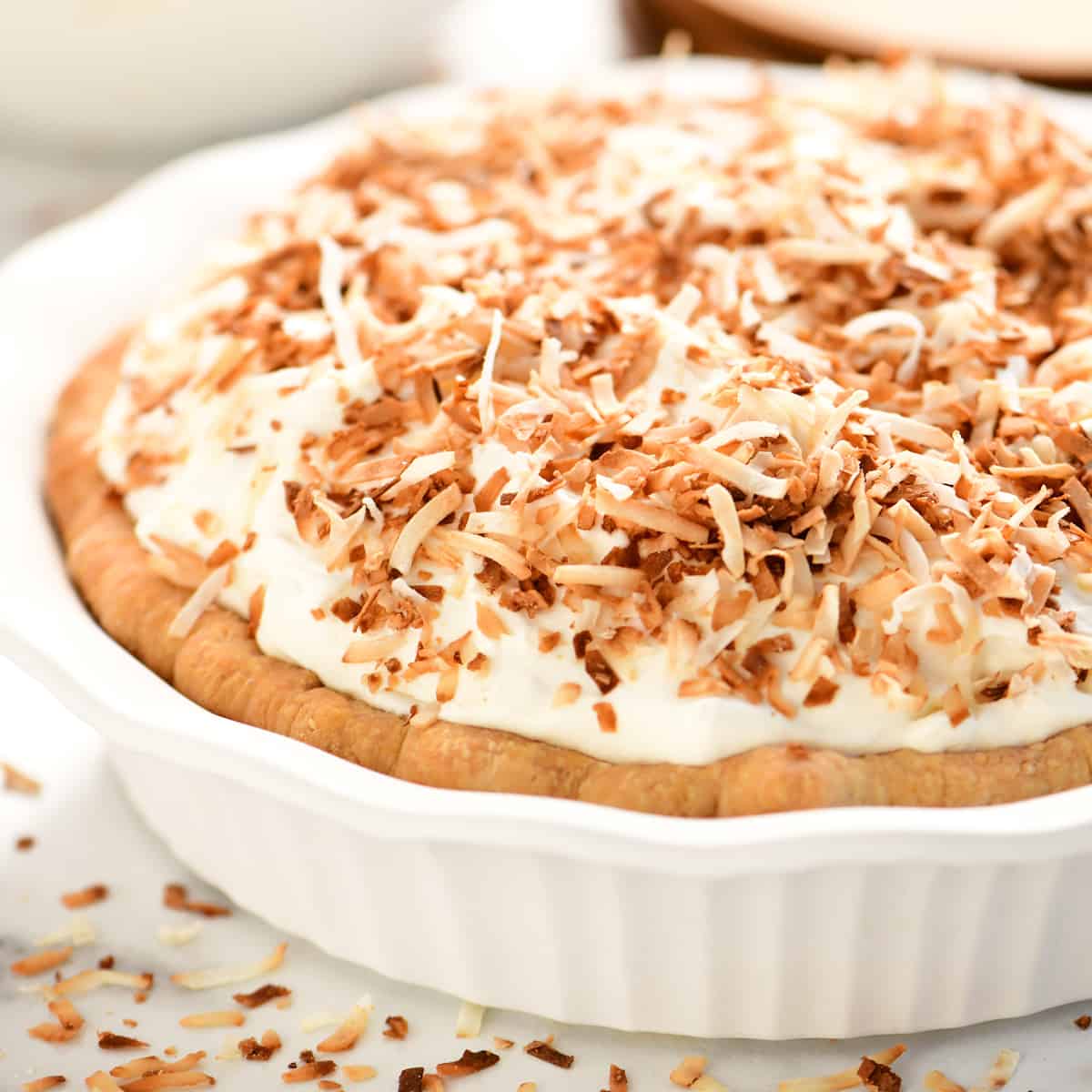 A coconut cream pie with toasted coconut on top