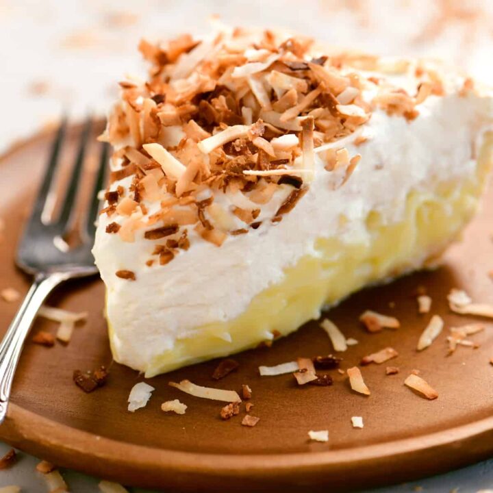 a close up view of a slice of coconut cream pie