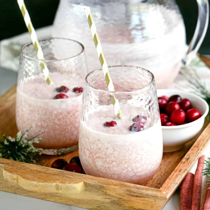 two glassed of frosted cranberry whip on a wooden tray
