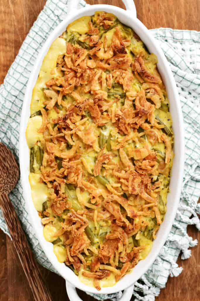 green bean casserole with french fried onions in a white oval dish