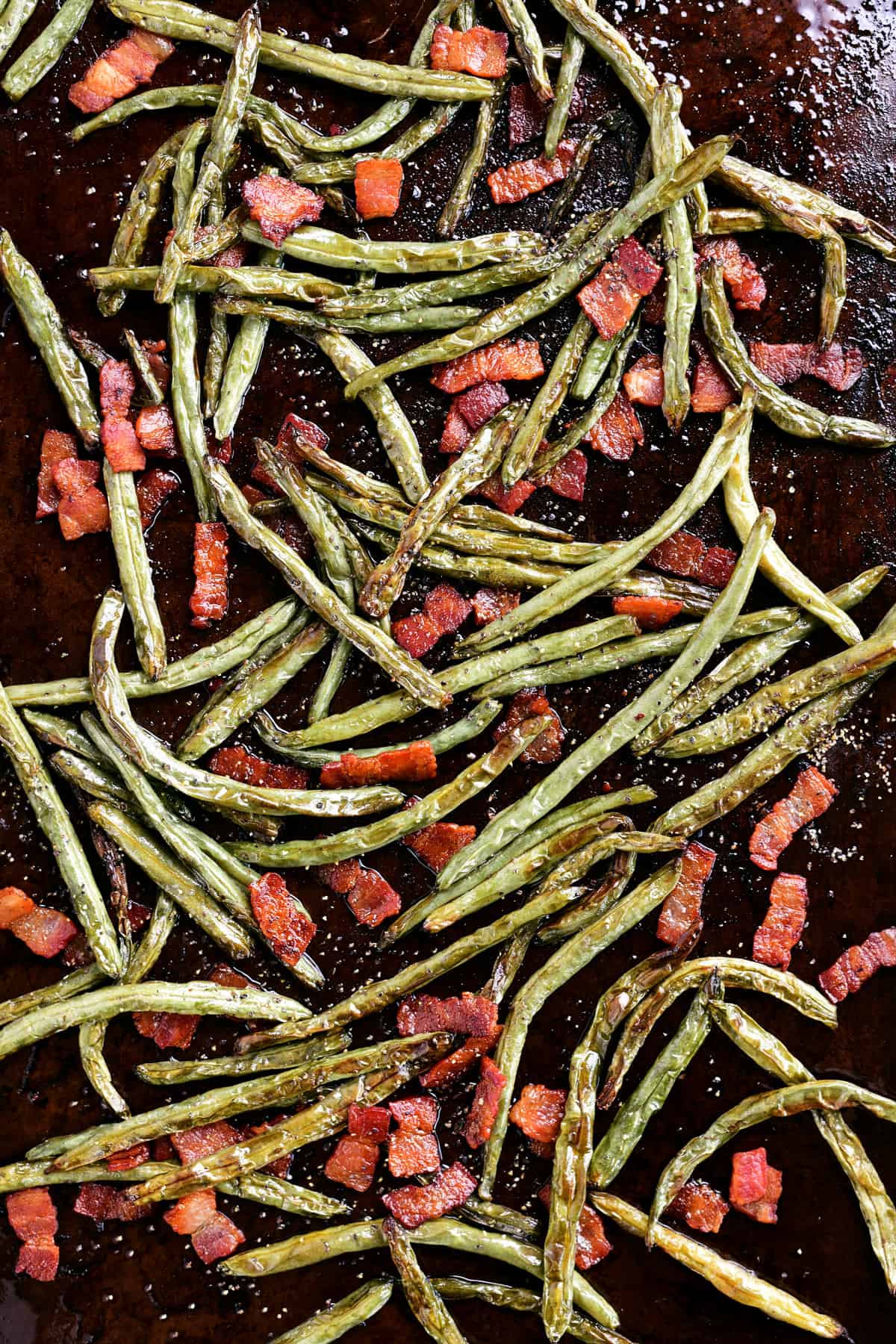 bacon, green beans and seasonings on a pan