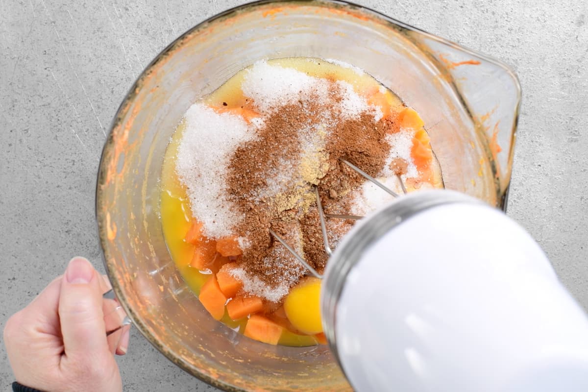 mixing sweet potatoes ingredients with an electric mixer
