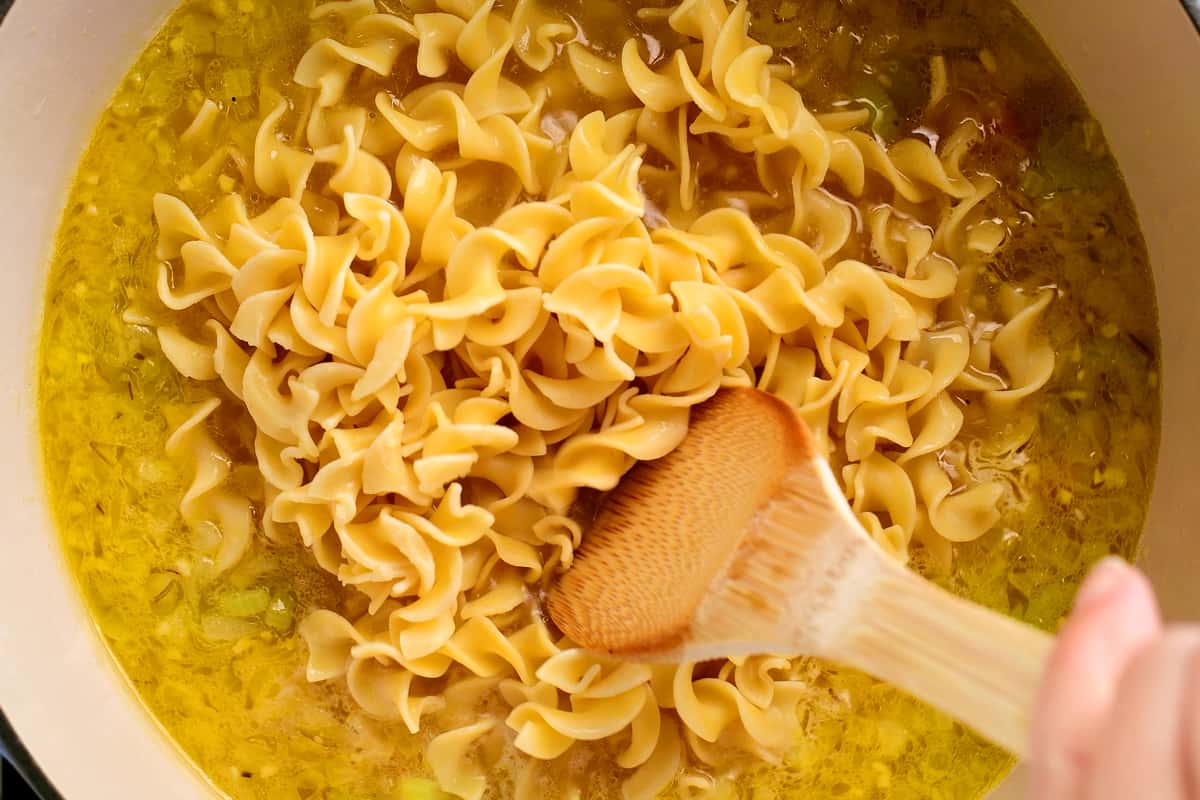 adding pasta to the soup