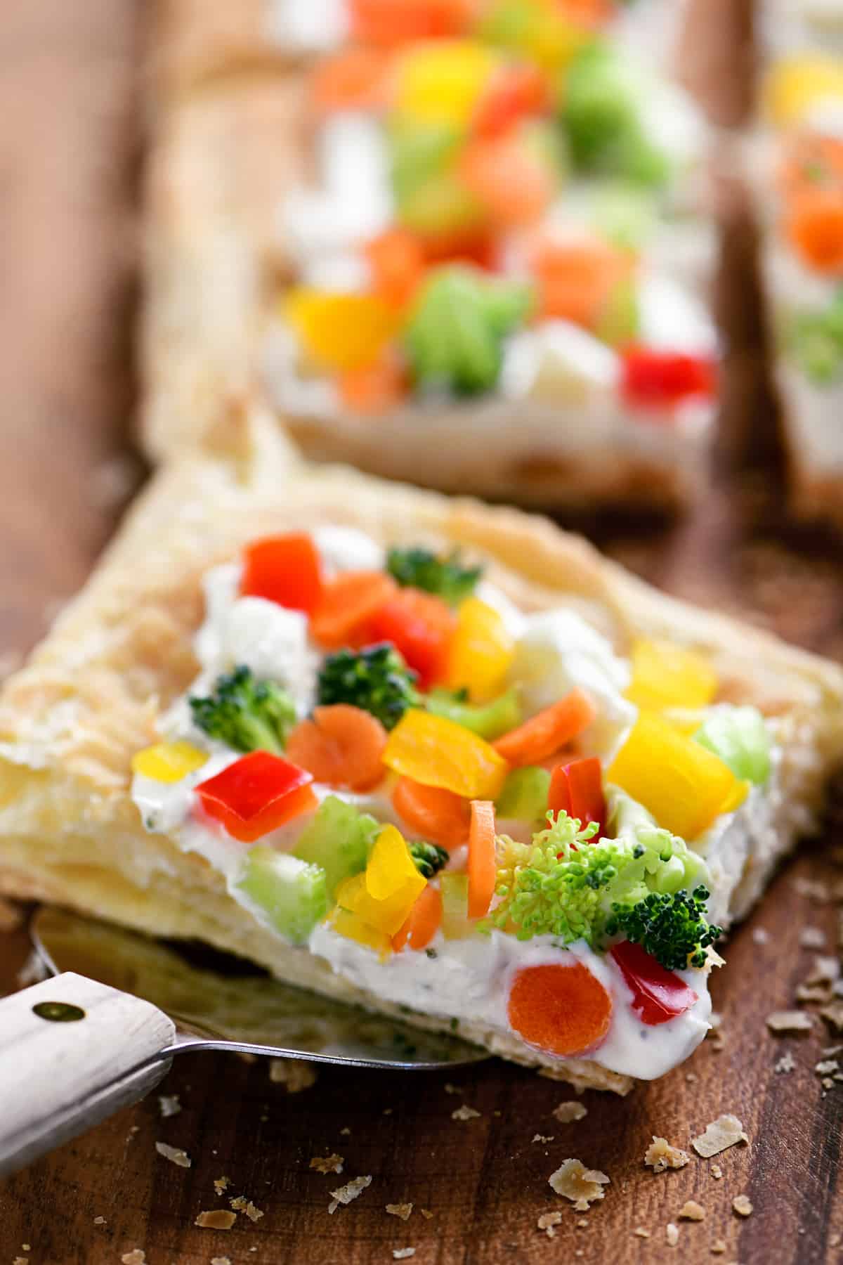a slice of vegetable pizza on a serving spatula