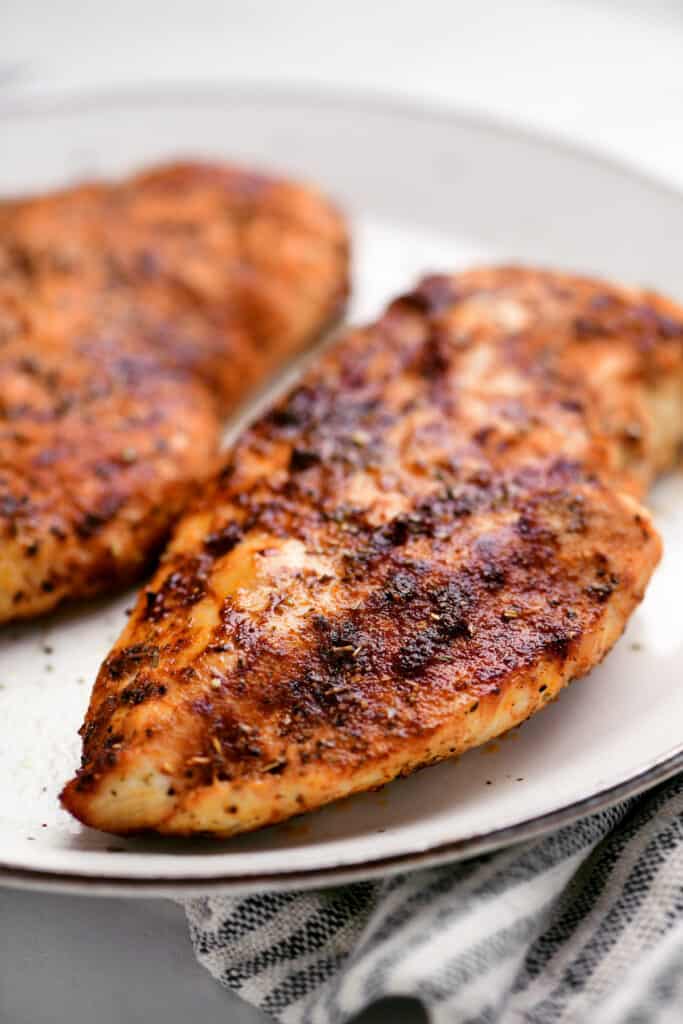 crispy seasoned chicken breast on a white plate