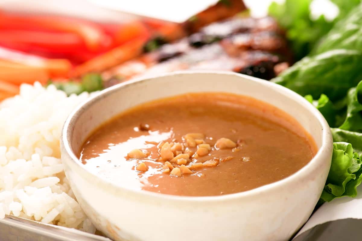 peanut sauce in a bowl with peanuts on top