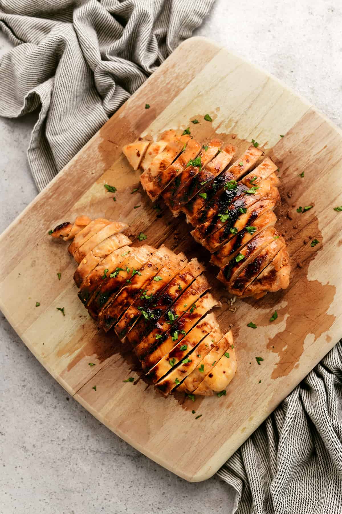 top down view of sliced sweet and spicy chicken breasts on a cutting board