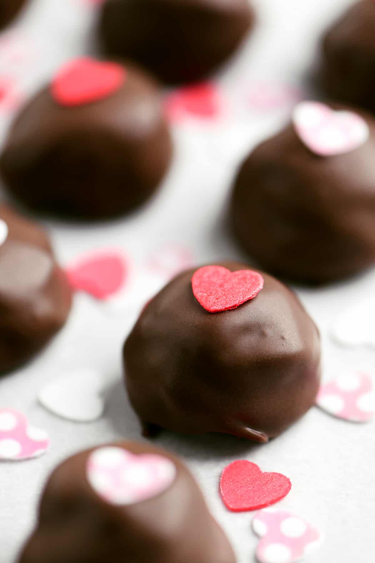 chocolate truffles with heart shaped candies on top