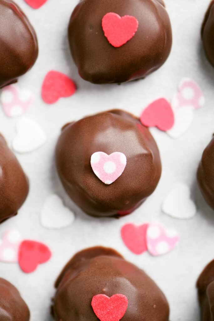 chocolate truffles with red and pink heart candies on top