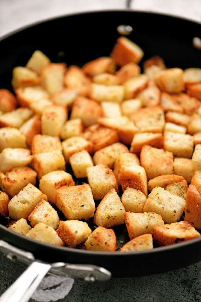 a frying pan with many croutons inside