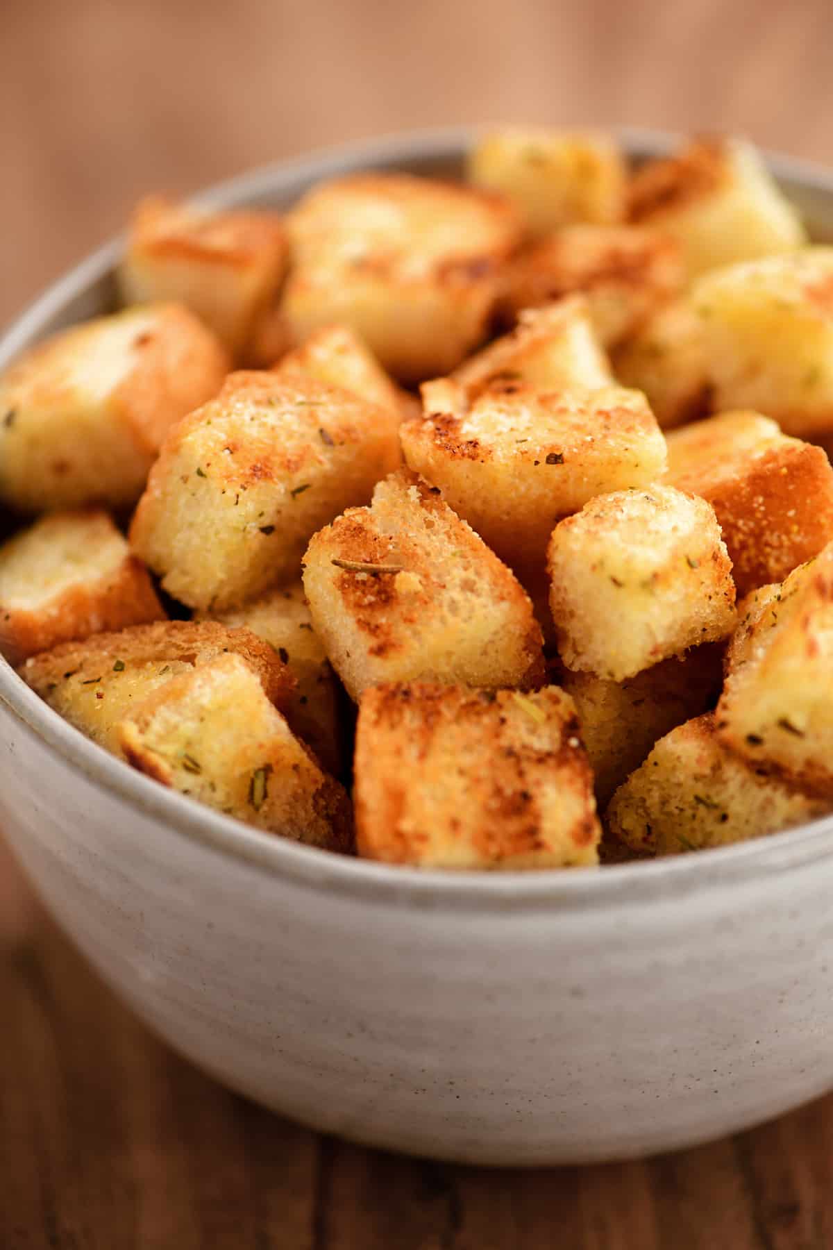 a bowl of croutons on a tabletop