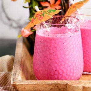 two glasses filled with a pink smoothie drink