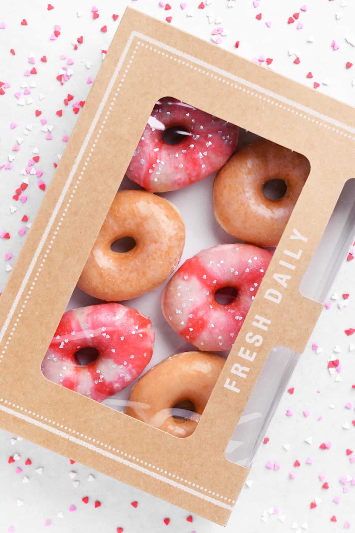 glazed donuts decorated for valentines day in a box