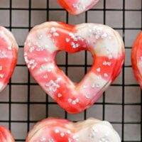 a wire rack with valentines donuts sitting on top