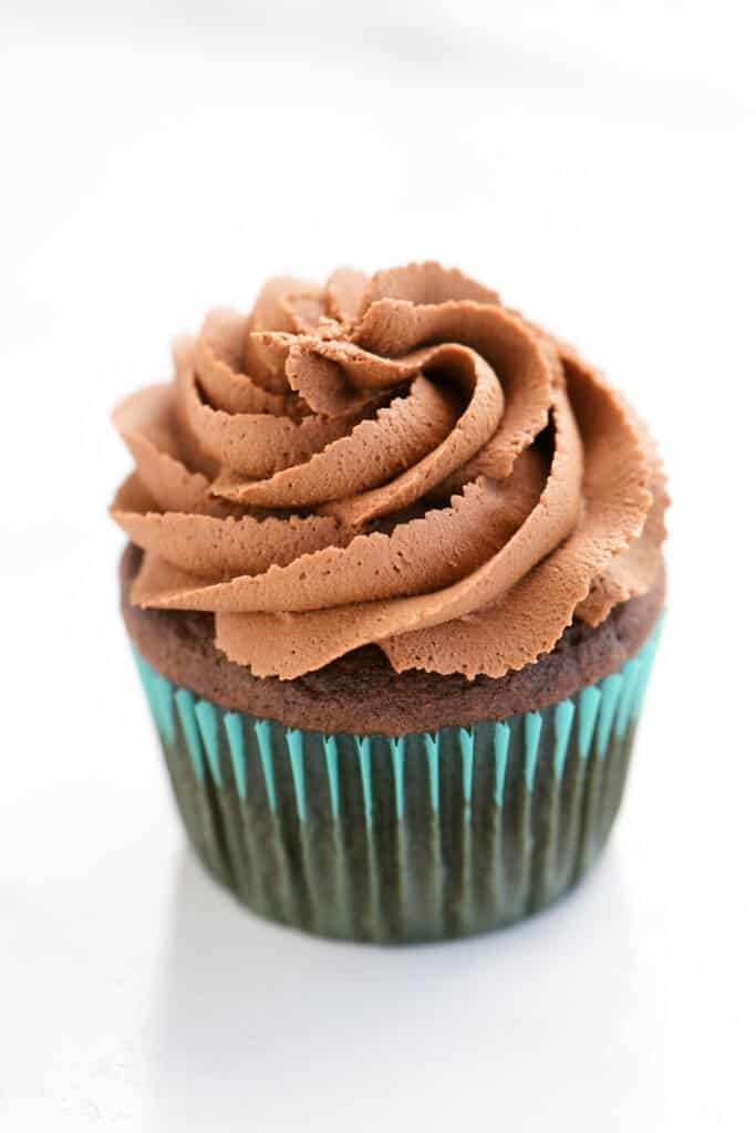 a cupcake frosted with chocolate buttercream