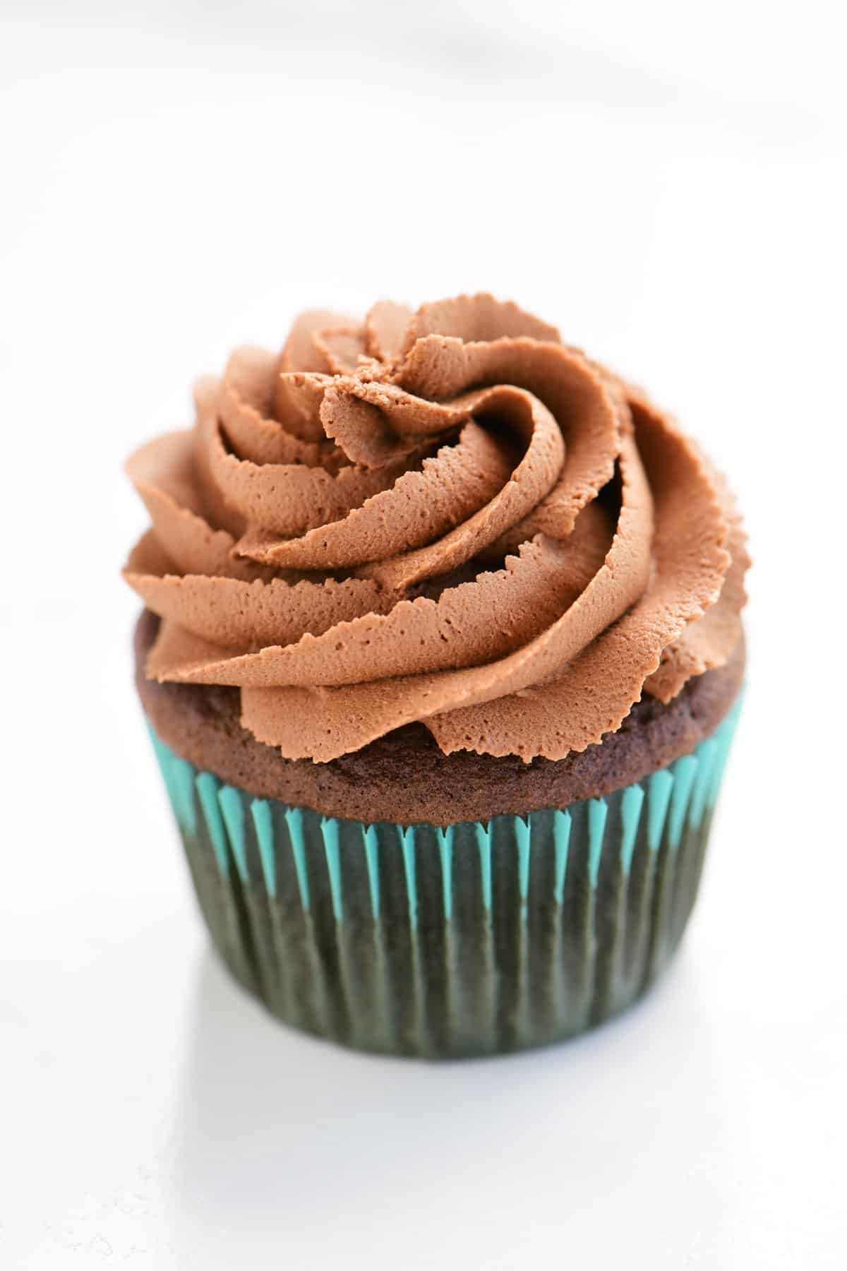 a cupcake frosted with chocolate buttercream