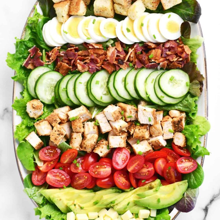 cobb salad ingredients lined up on a tray