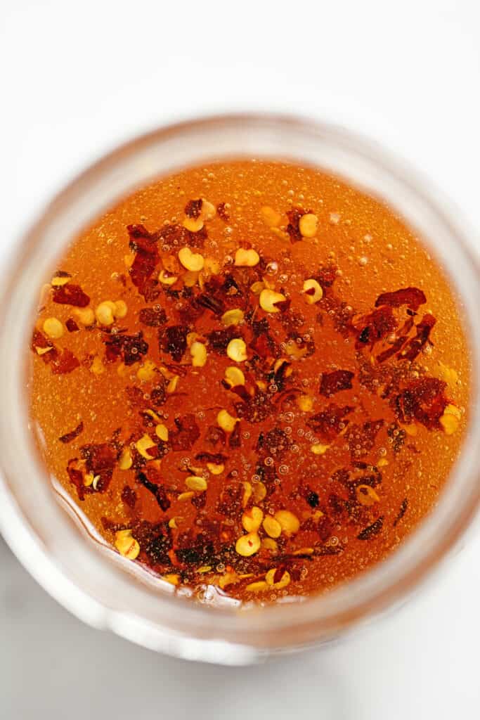 red pepper flakes in jar of honey