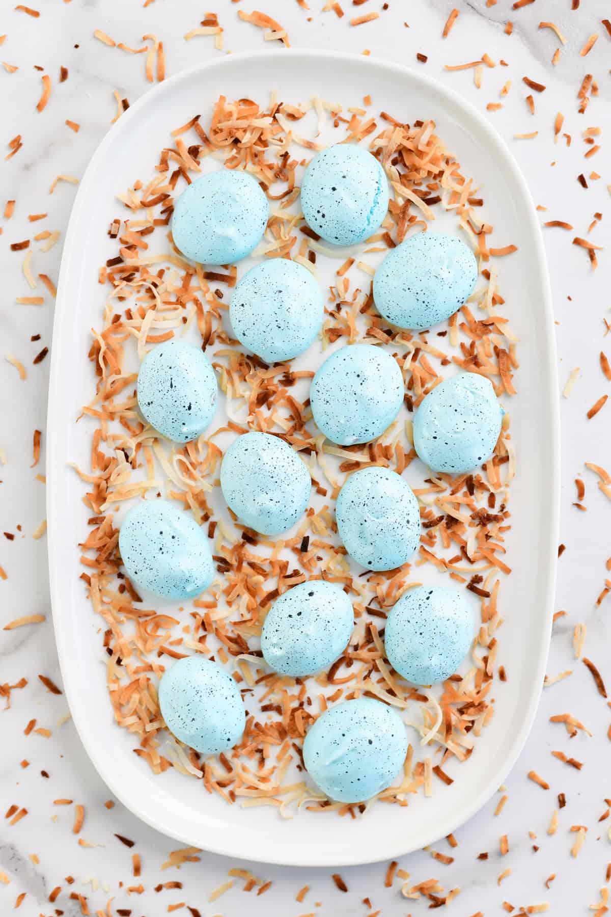 robins egg meringue cookies on a white platter