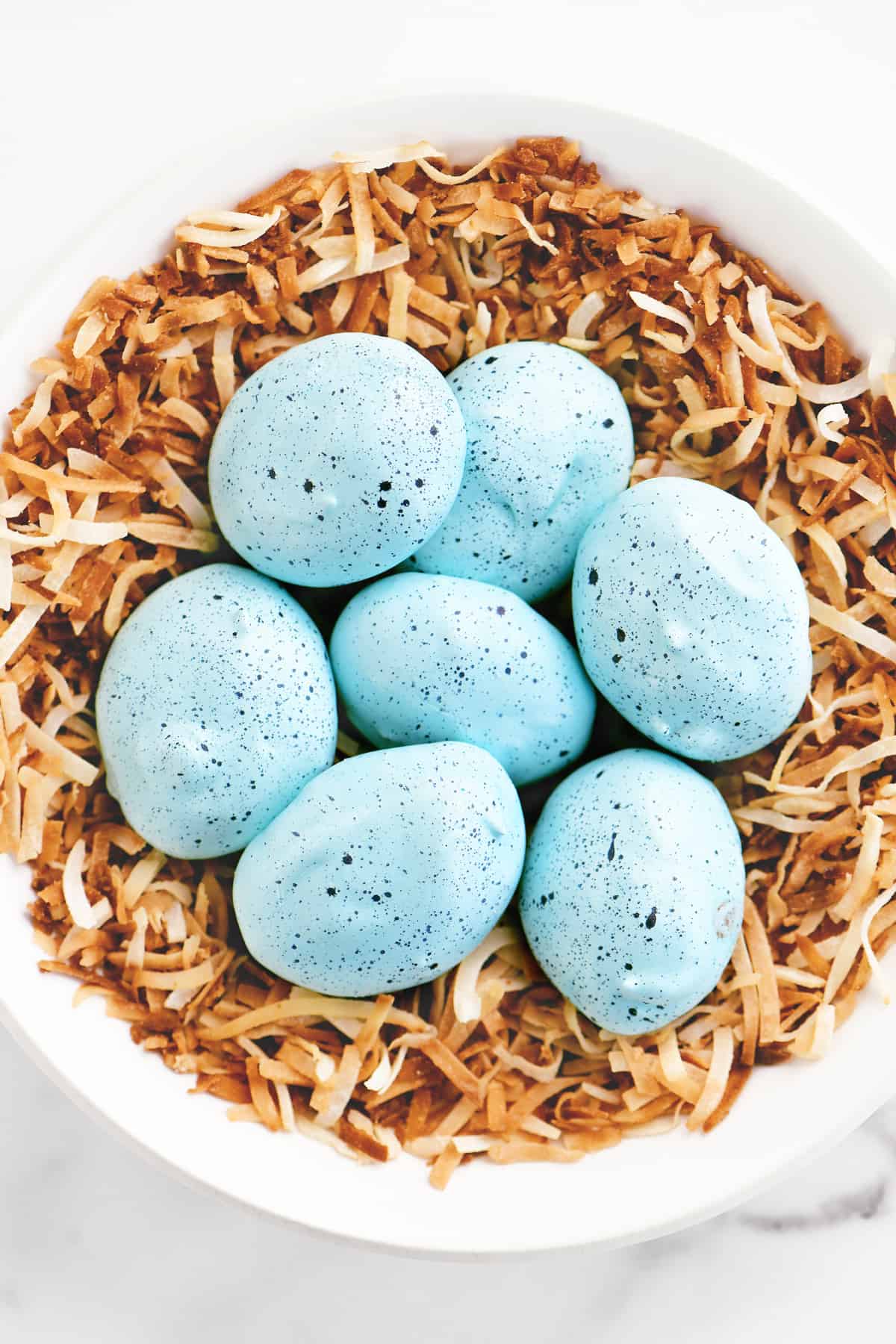 seven robins egg meringue cookies in a bowl