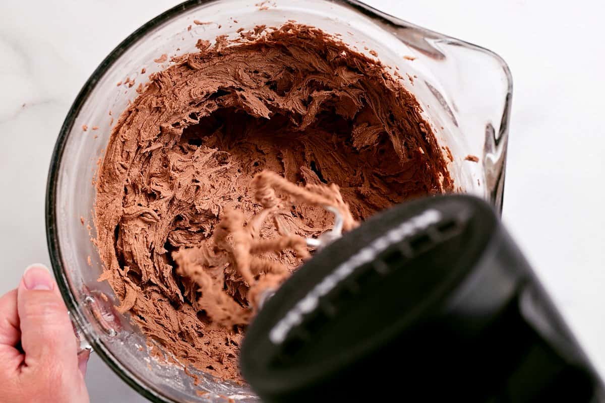 a mixer shown mixing the chocolate buttercream frosting