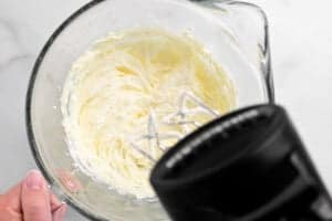 a mixer mixing the butter into the frosting