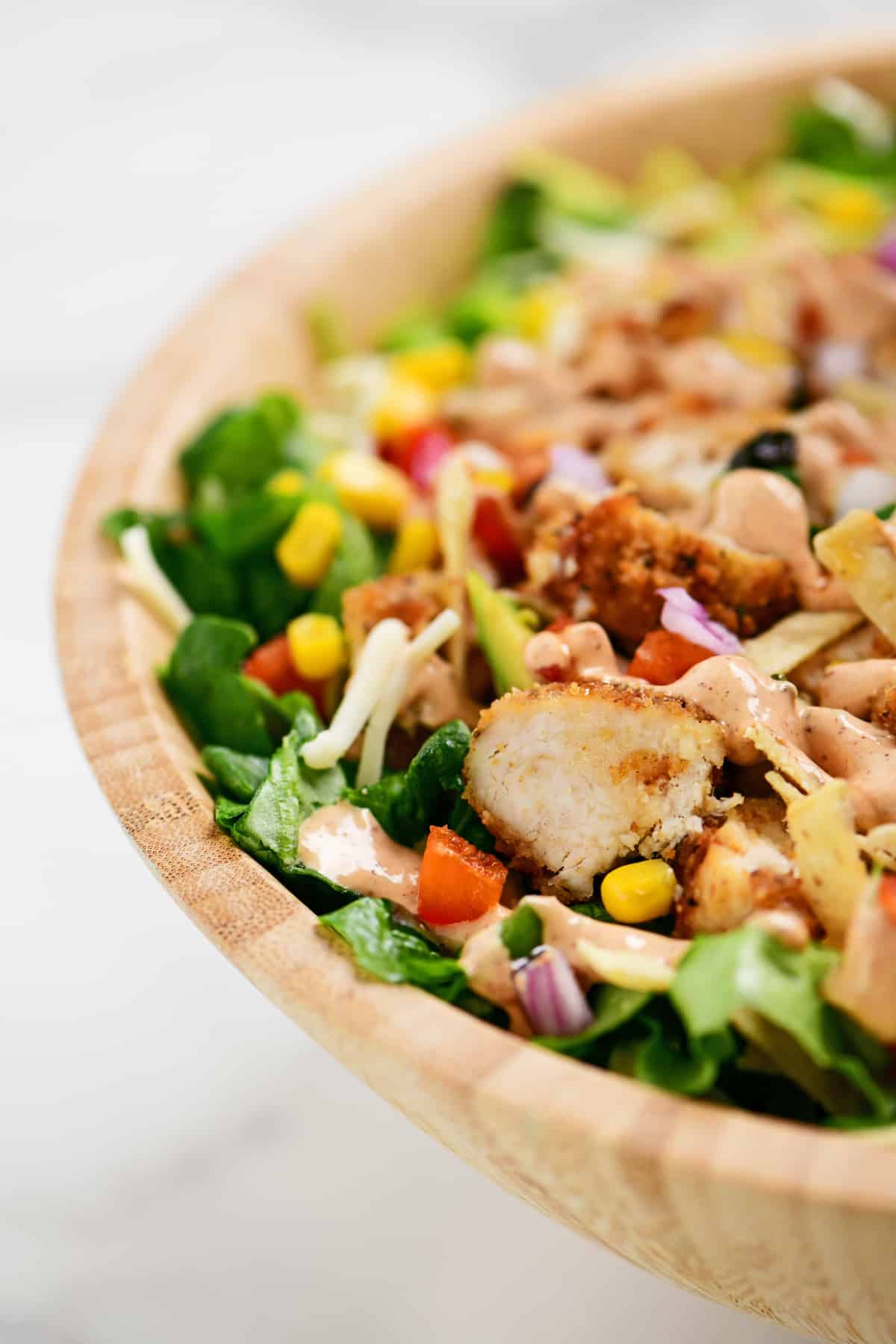 chipotle chicken salad in a wooden bowl