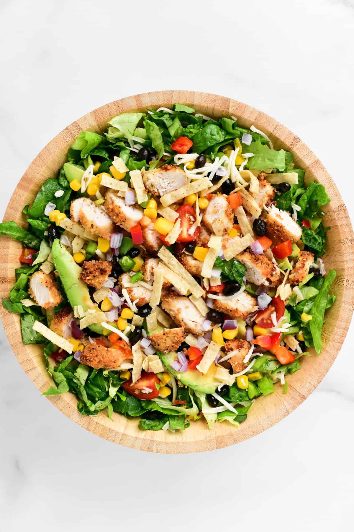 a wooden bowl full of chipotle chicken salad