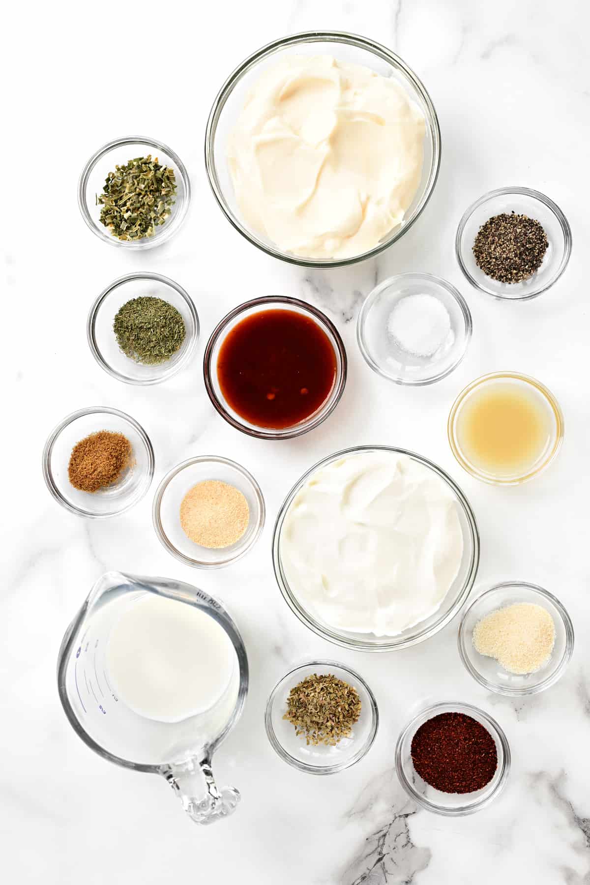 several different ingredients used to make dressing set out on a counter top